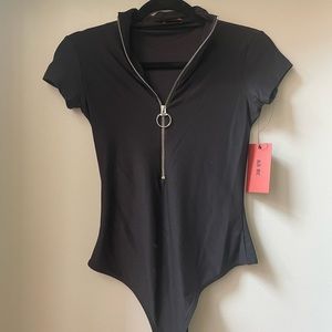 Never worn!! ALIX NYC zip up body suit - size small.